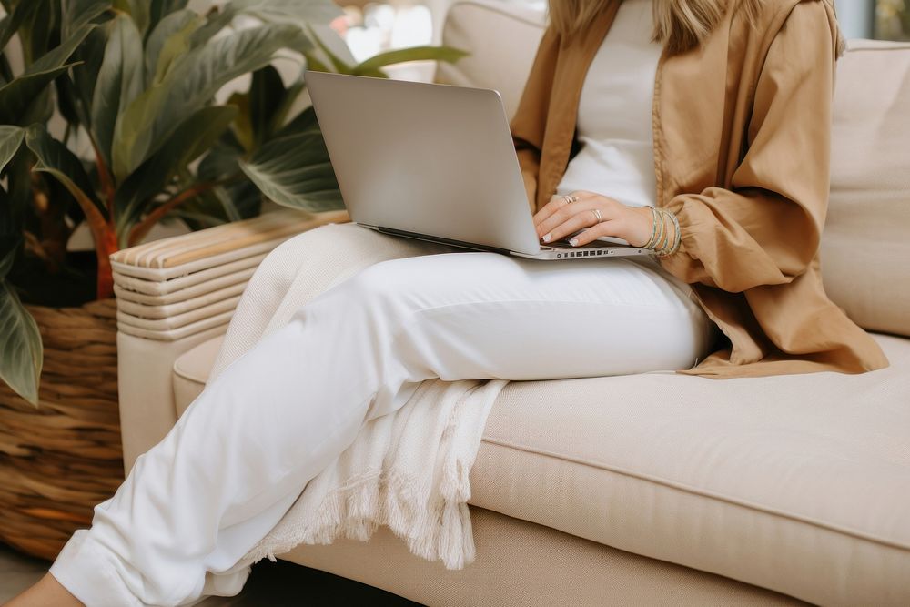 Laptop sitting furniture computer. AI generated Image by rawpixel.