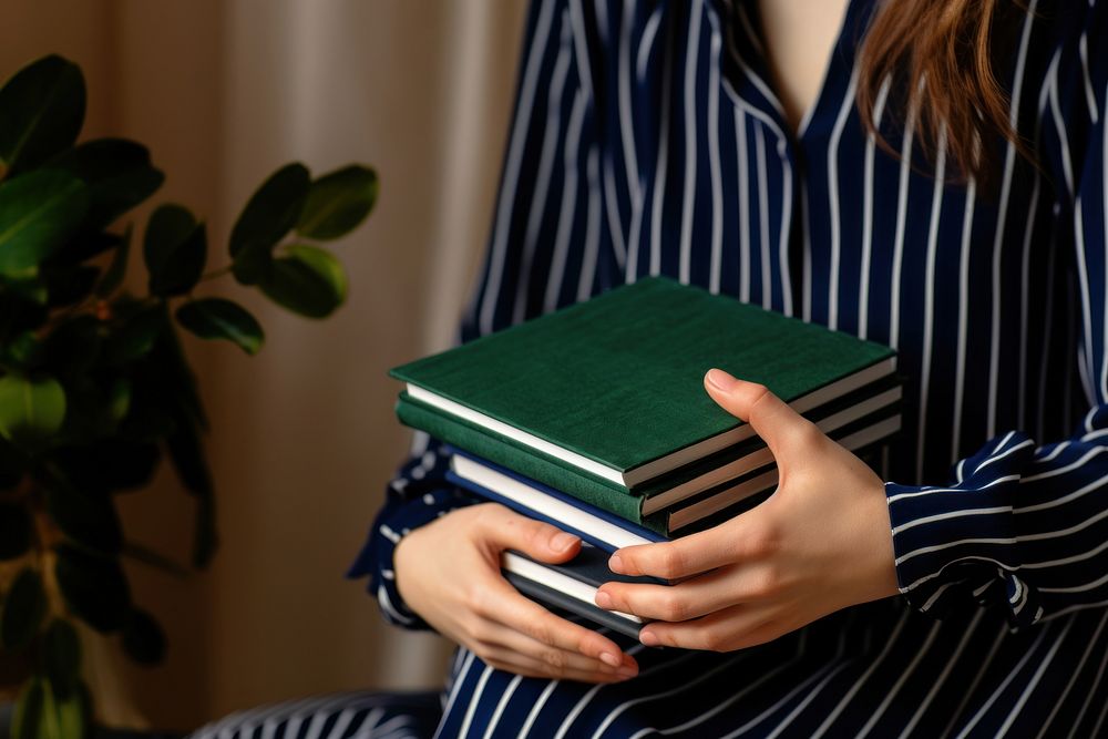 Woman holding stacked books. AI generated Image by rawpixel.