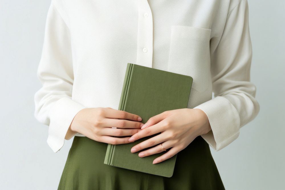 Hand holding velvet green notebook pattern sleeve person. AI generated Image by rawpixel.