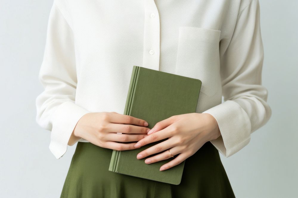 Hand holding velvet green notebook pattern sleeve person. 