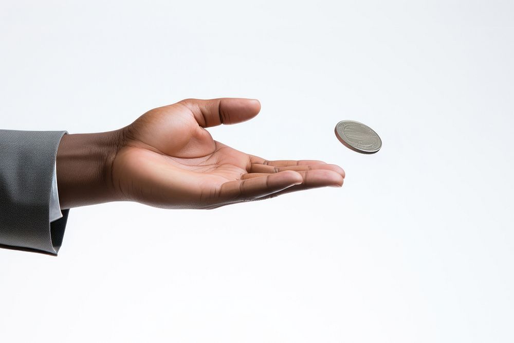 Businessman's hand tossing a coin. 