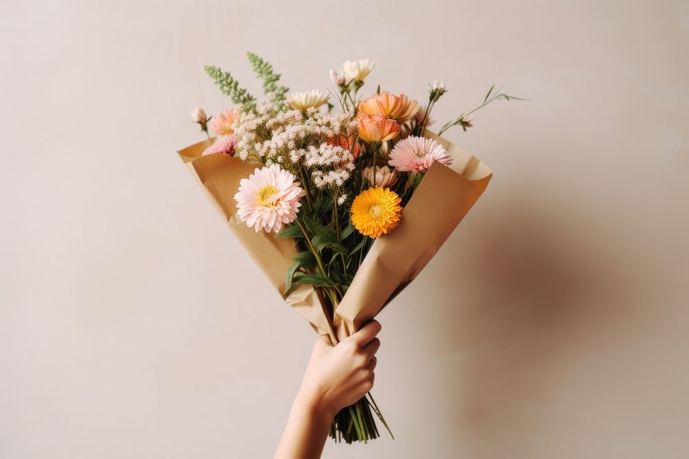 Holding flower bouquet plant daisy rose. 