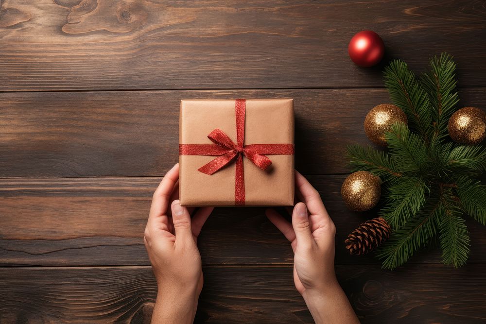 Hands exchanging gift box christmas wood anticipation. AI generated Image by rawpixel.