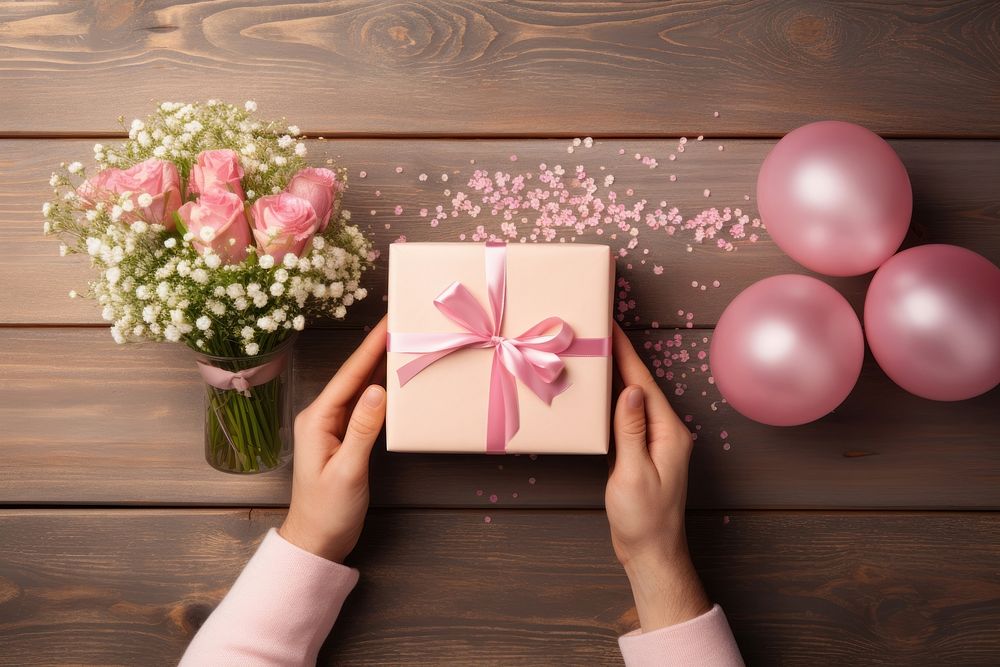 Hands exchanging gift box birthday balloon flower. AI generated Image by rawpixel.