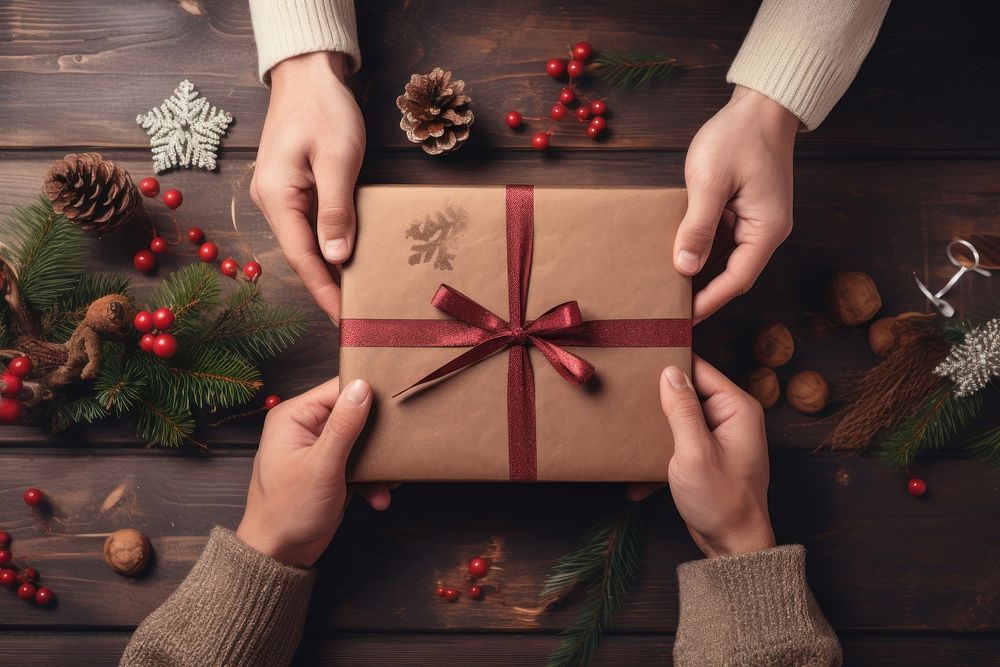 Hands exchanging gift box christmas celebration anniversary. AI generated Image by rawpixel.