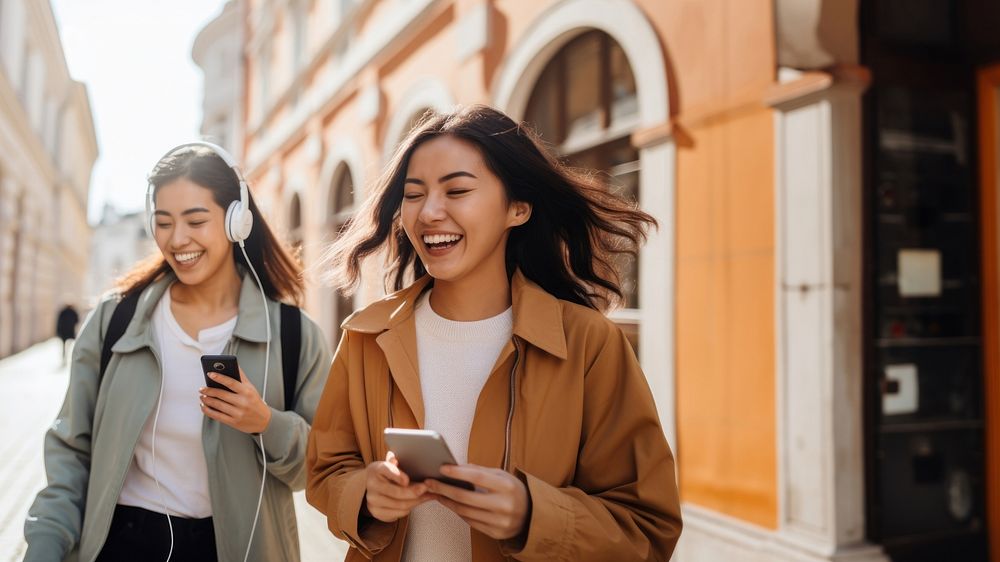 Two female asian friends laughing walking adult. 