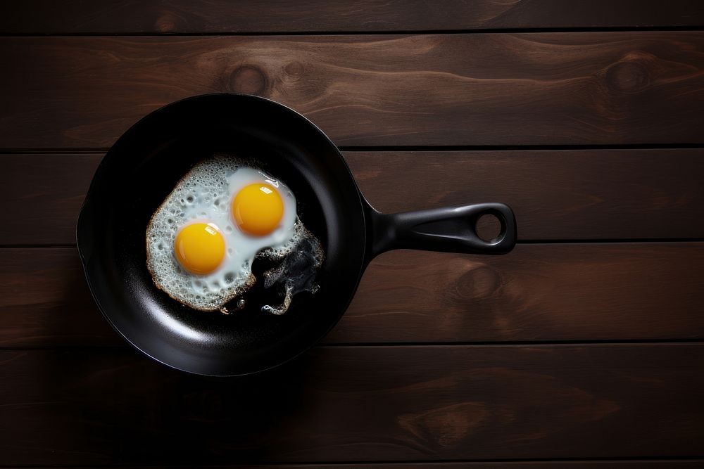 Fried eggs table food wood. AI generated Image by rawpixel.