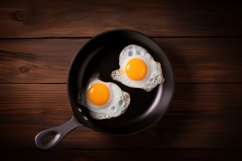 Fried eggs table food wood. AI generated Image by rawpixel.