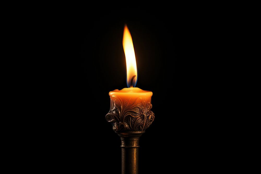 Candle light fire black background illuminated. 