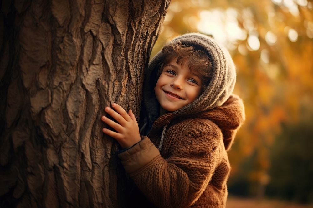 Kid hugging tree smiling happiness innocence. 