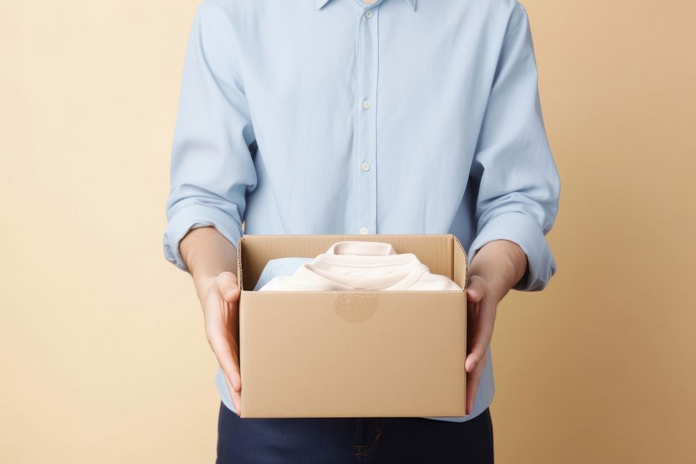 Give clothes box cardboard holding. AI generated Image by rawpixel.