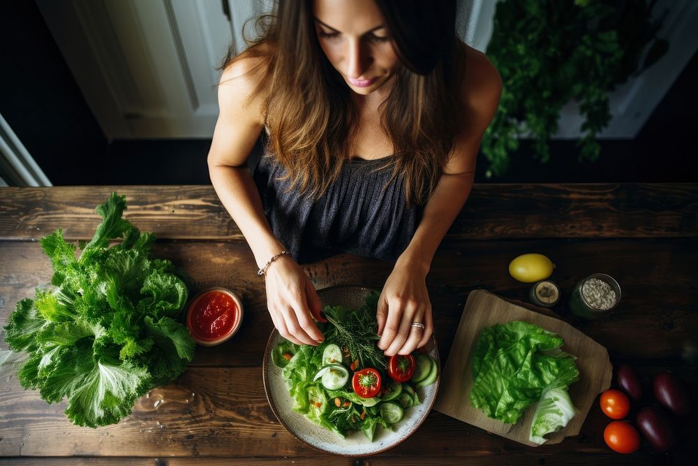 Woman eating salad vegetable food ingredient. AI generated Image by rawpixel.