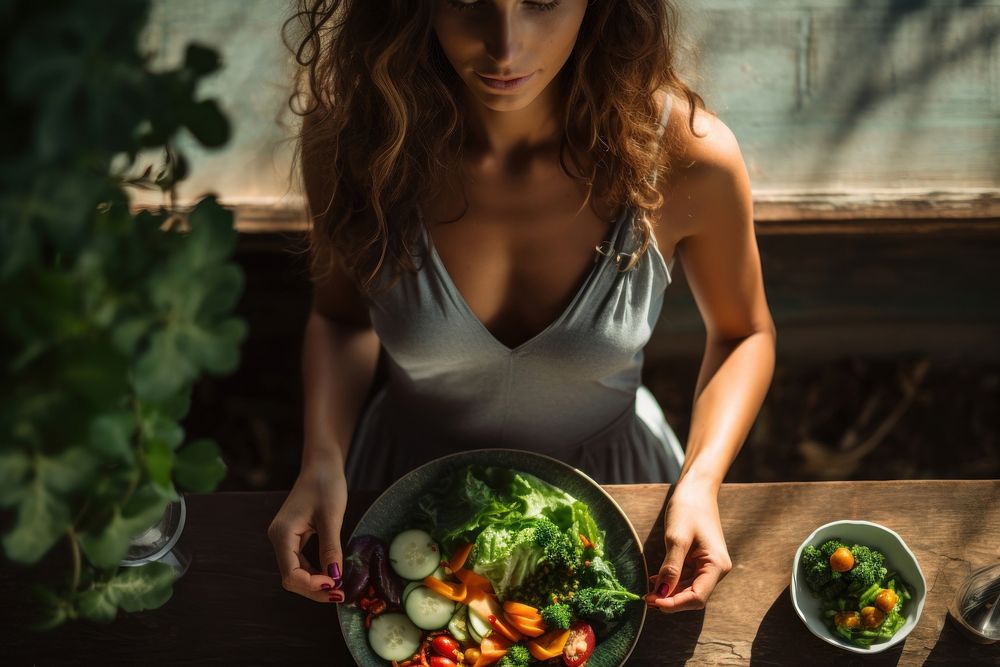 Woman eating salad vegetable adult food. AI generated Image by rawpixel.