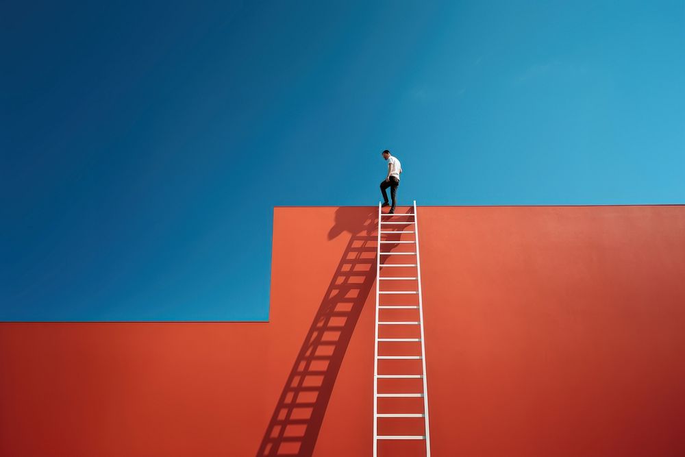 Photography of a man climbing a ladder to the roof.  