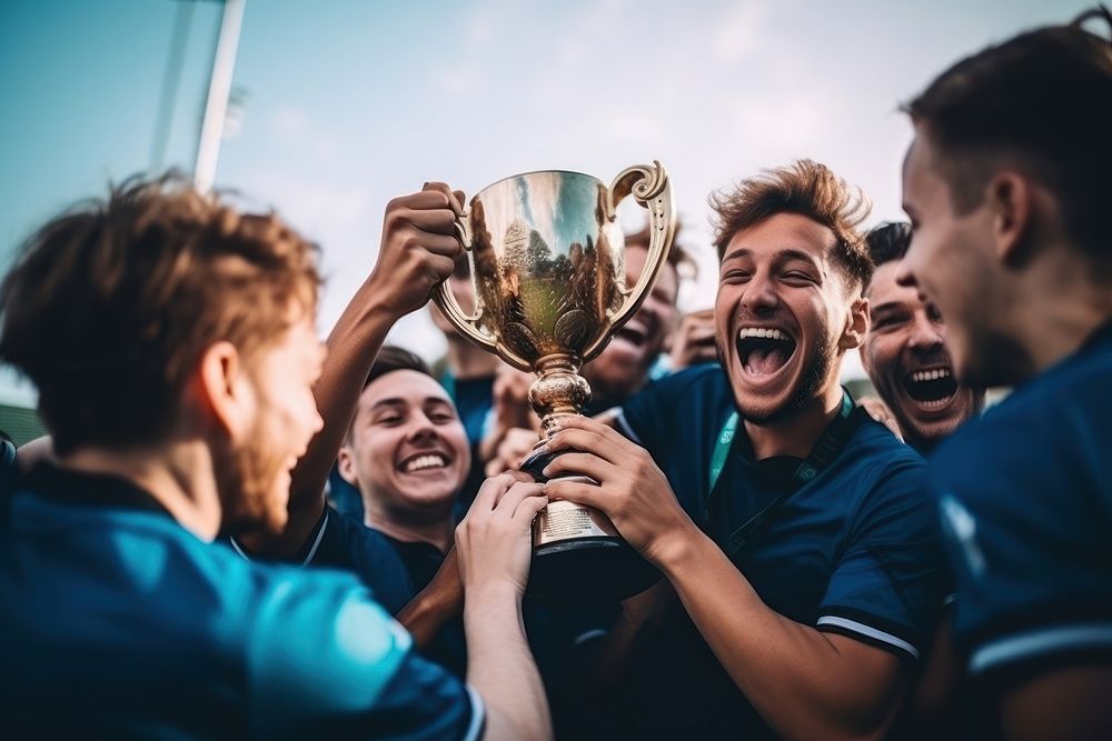 Football team holding trophy cheerful laughing adult. AI generated Image by rawpixel.