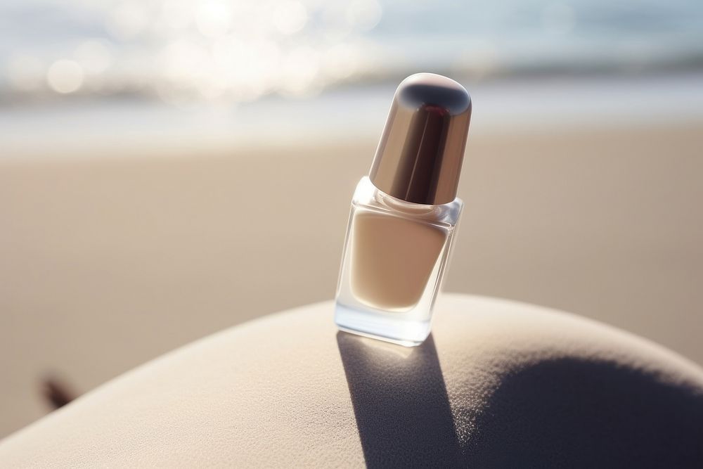 Nail polish bottle cosmetics beach day. 