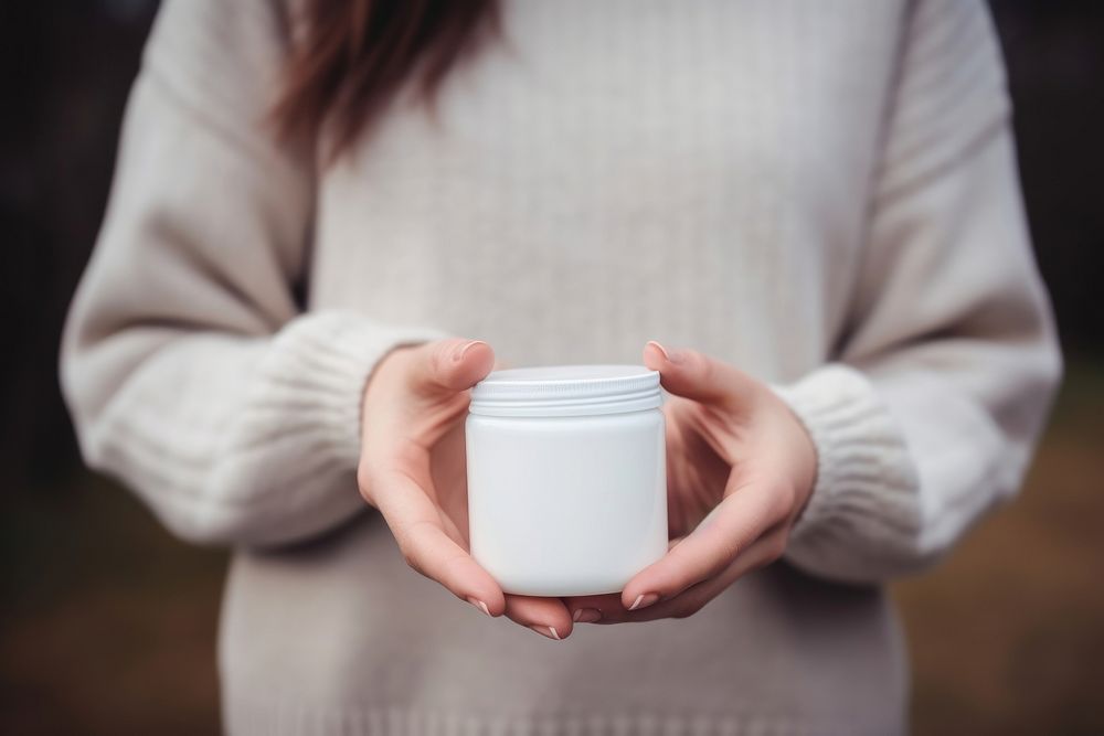 Sweater holding white refreshment. AI generated Image by rawpixel.