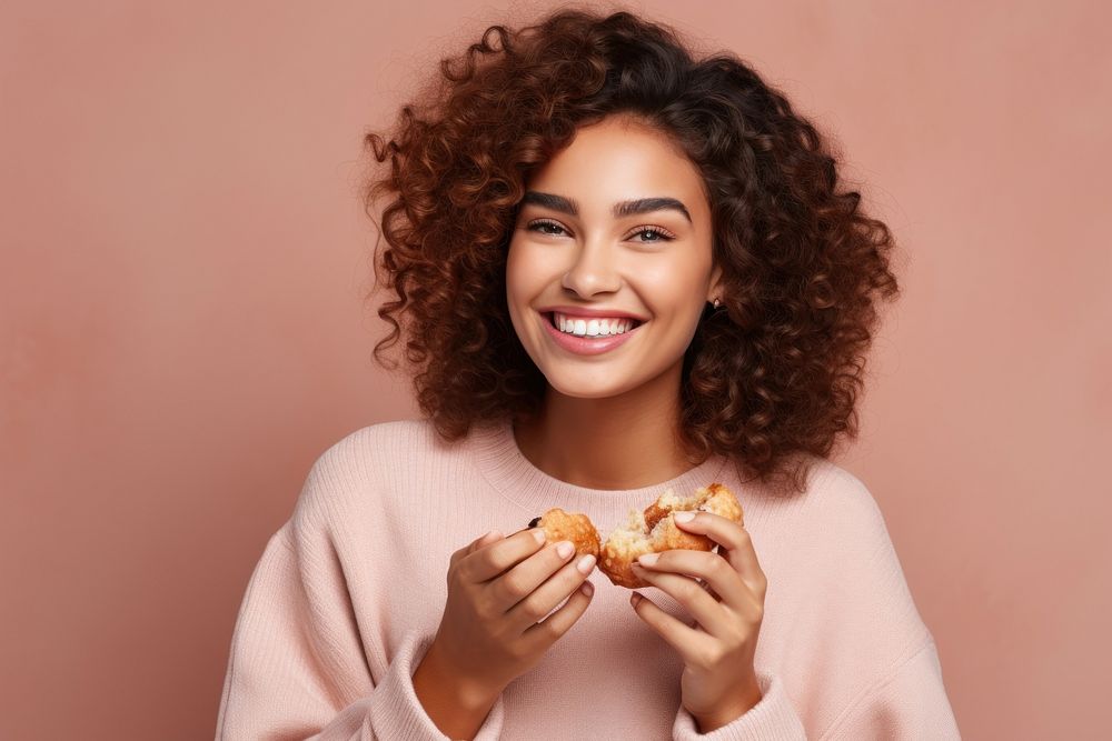 Young woman eating pastry portrait biting adult. AI generated Image by rawpixel.