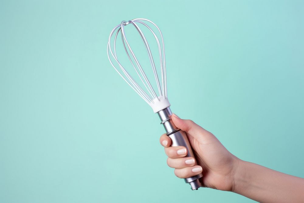 Egg beater holding hand electricity. 