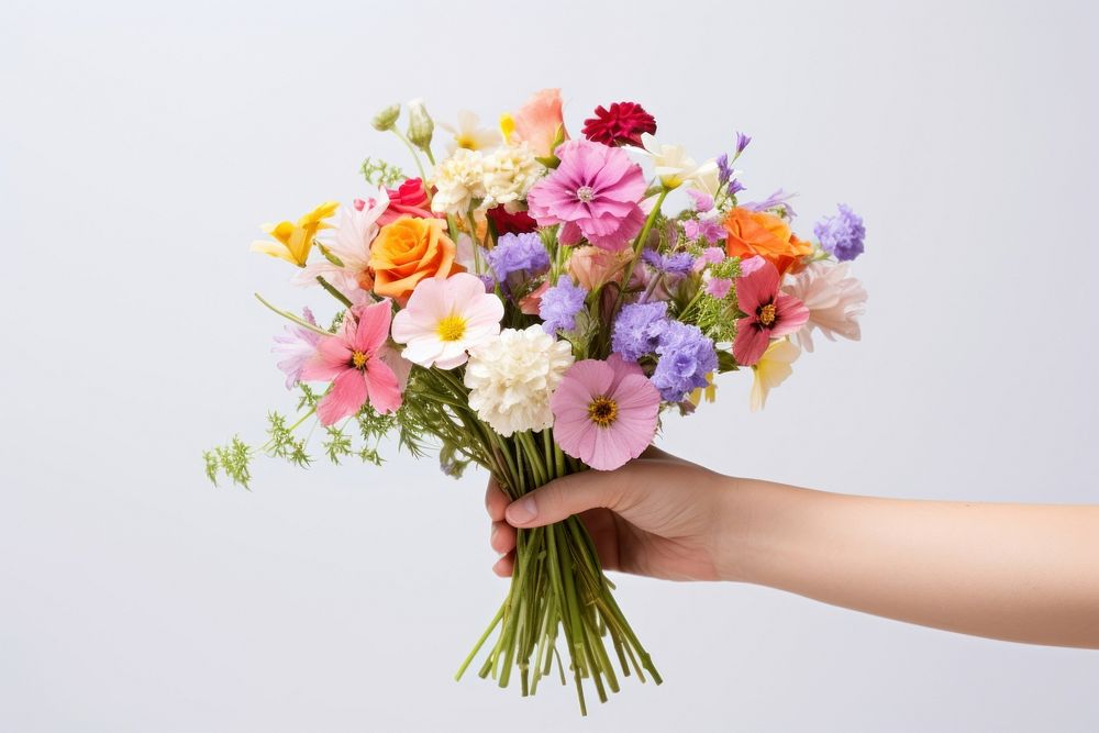 Hand holding flower bouquet plant rose inflorescence. AI generated Image by rawpixel.
