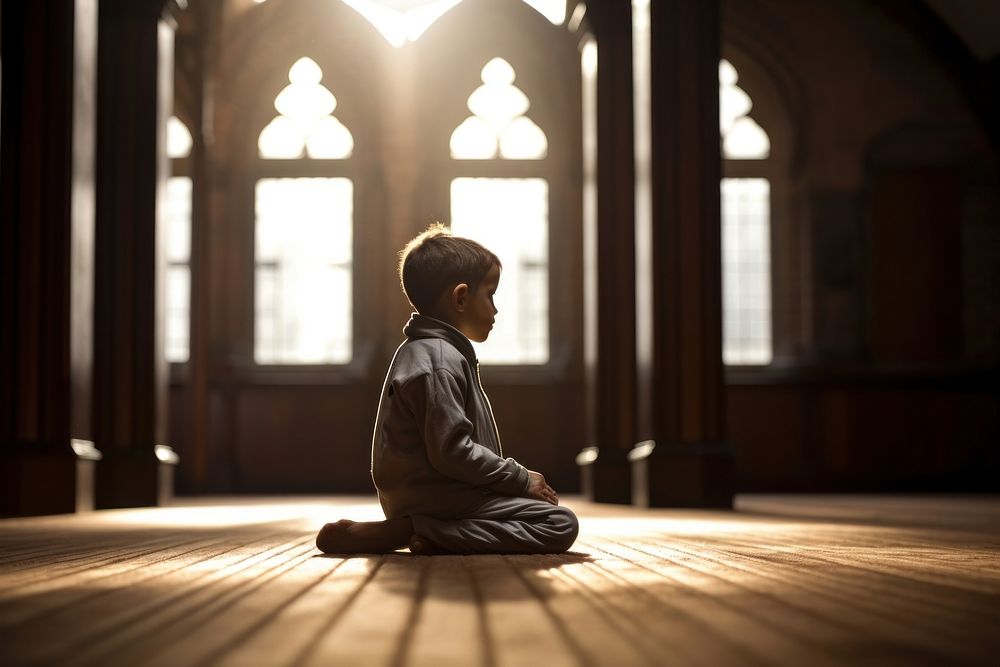 Sitting praying light child. 