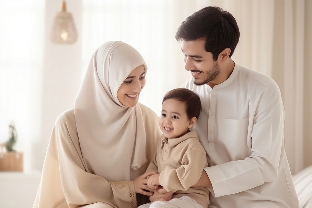 Happy Muslim family reading quran together smiling father child. 