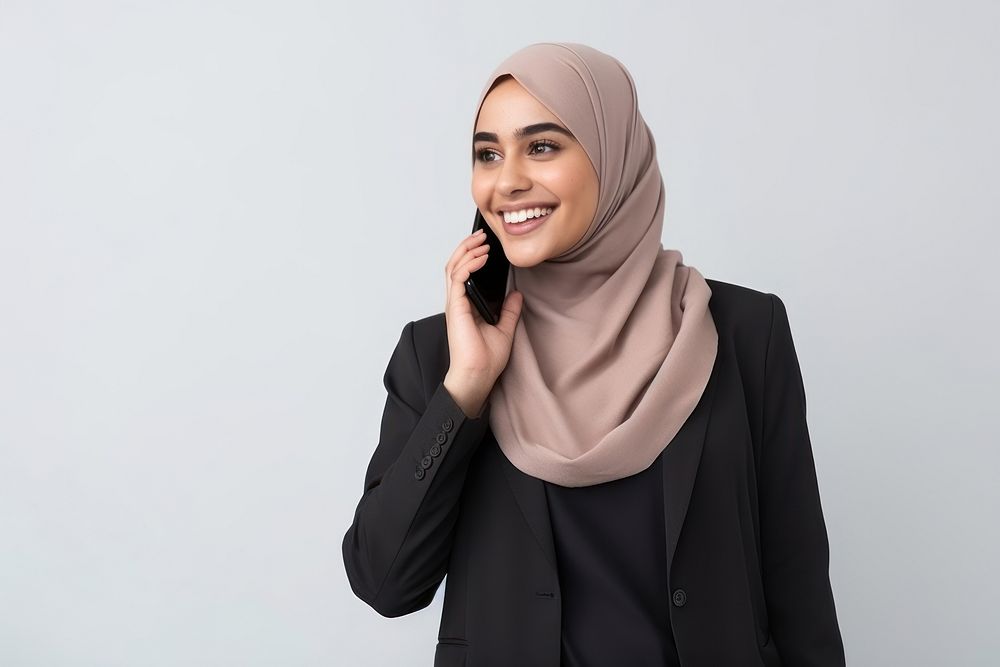 Young Muslim woman calling mobile phone smiling scarf adult. AI generated Image by rawpixel.