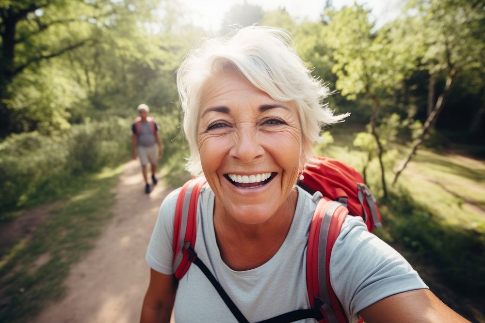 Senior woman laughing outdoors smiling. AI generated Image by rawpixel.