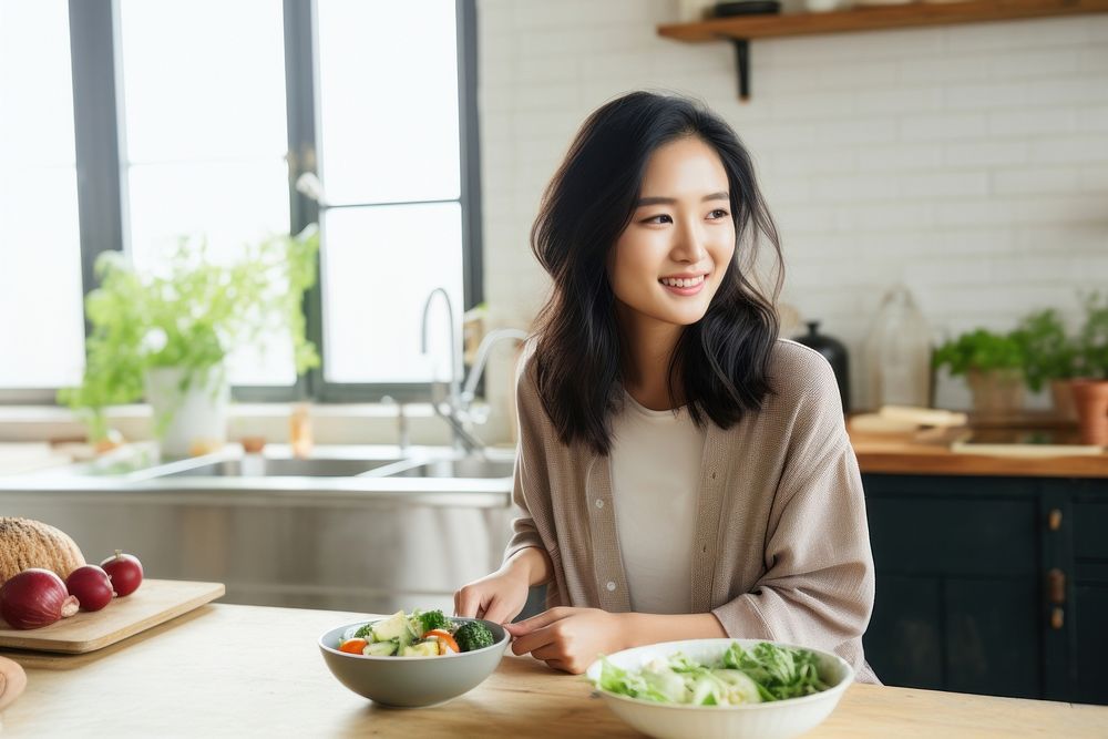 Asian woman smiling kitchen eating. AI generated Image by rawpixel.