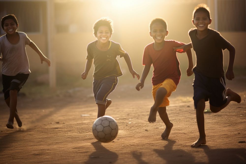 Kids playing football running smiling sports. AI generated Image by rawpixel.