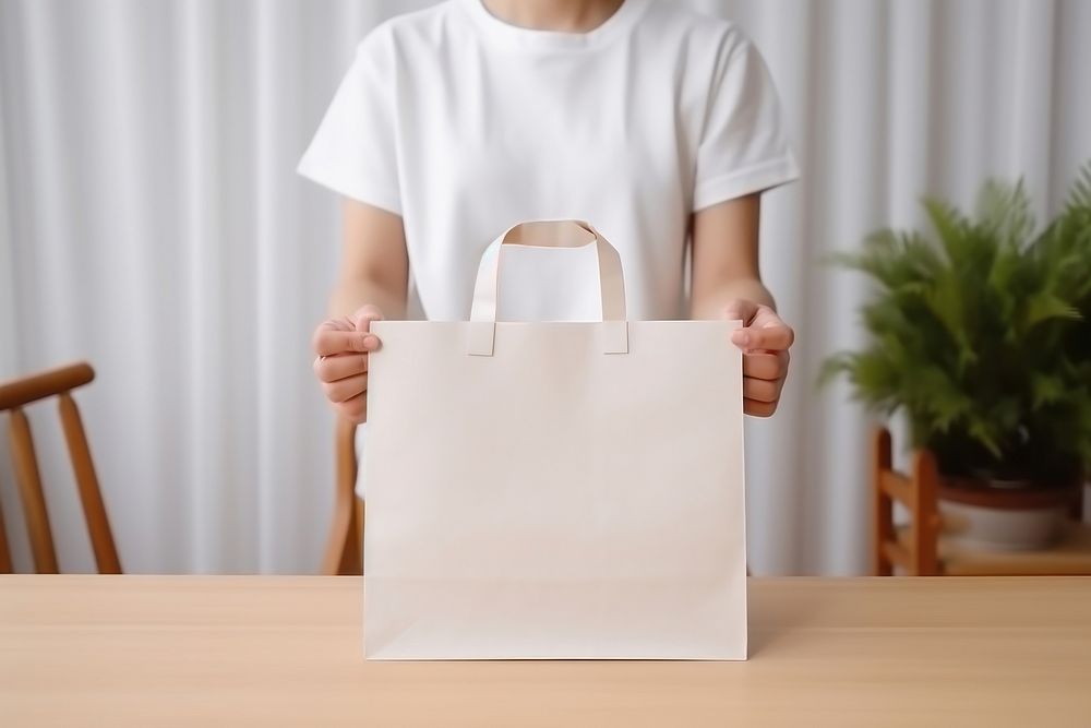 Shopping bag handbag holding white. AI generated Image by rawpixel.