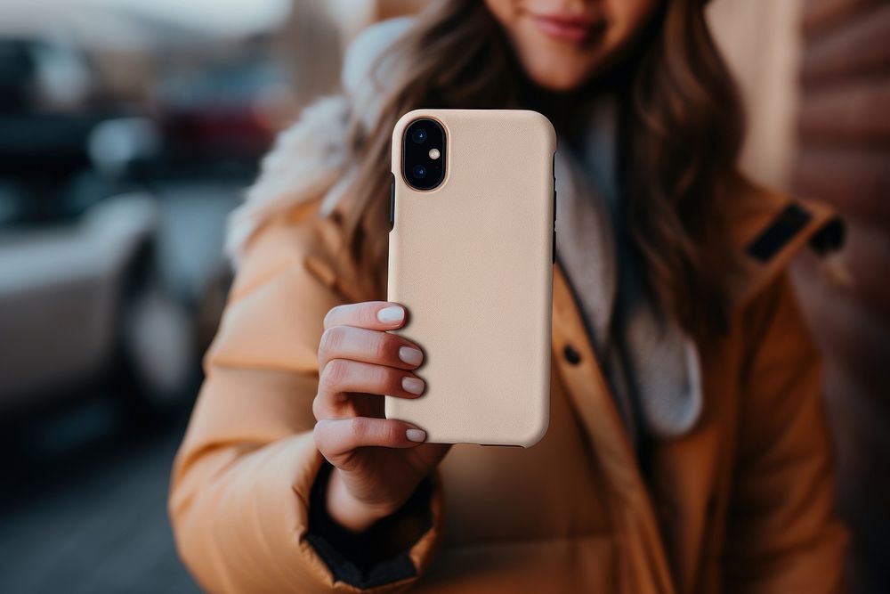 Smartphone case holding selfie photo. 