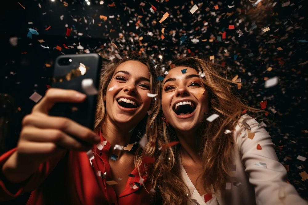 Laughing confetti holding selfie. AI generated Image by rawpixel.