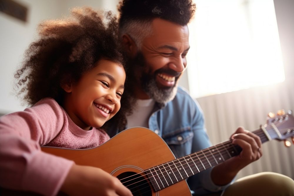 Dad teaching daughter play guitar musician togetherness affectionate. 