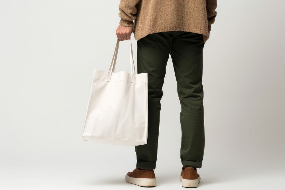 Shopping bag handbag pants adult. AI generated Image by rawpixel.