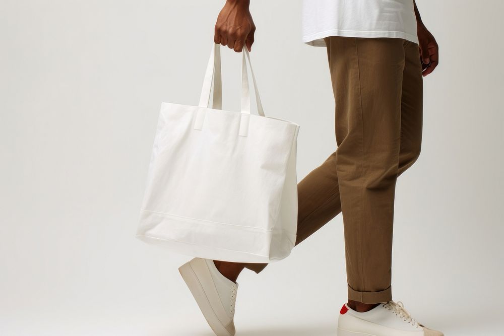 Shopping bag footwear handbag adult. AI generated Image by rawpixel.