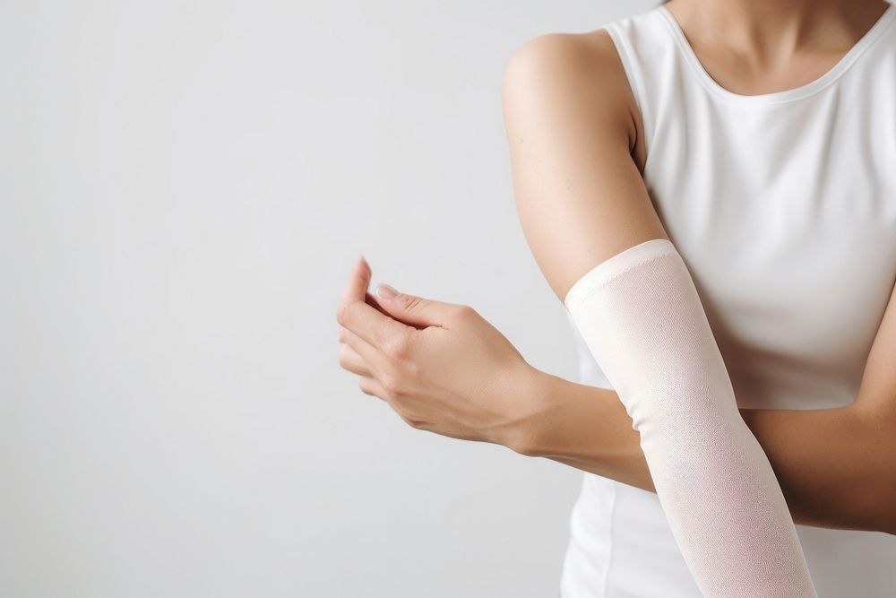 Physiotherapist massaging female patient pain arm midsection. AI generated Image by rawpixel.
