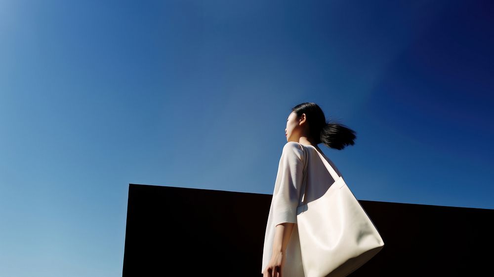 Asian woman holding a big tote bag walking fashion adult. AI generated Image by rawpixel.