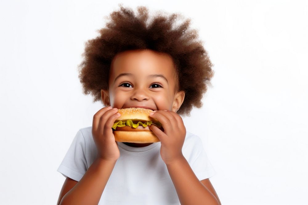 Cute little african boy enjoy eating a hamburger have fun biting food cute. 