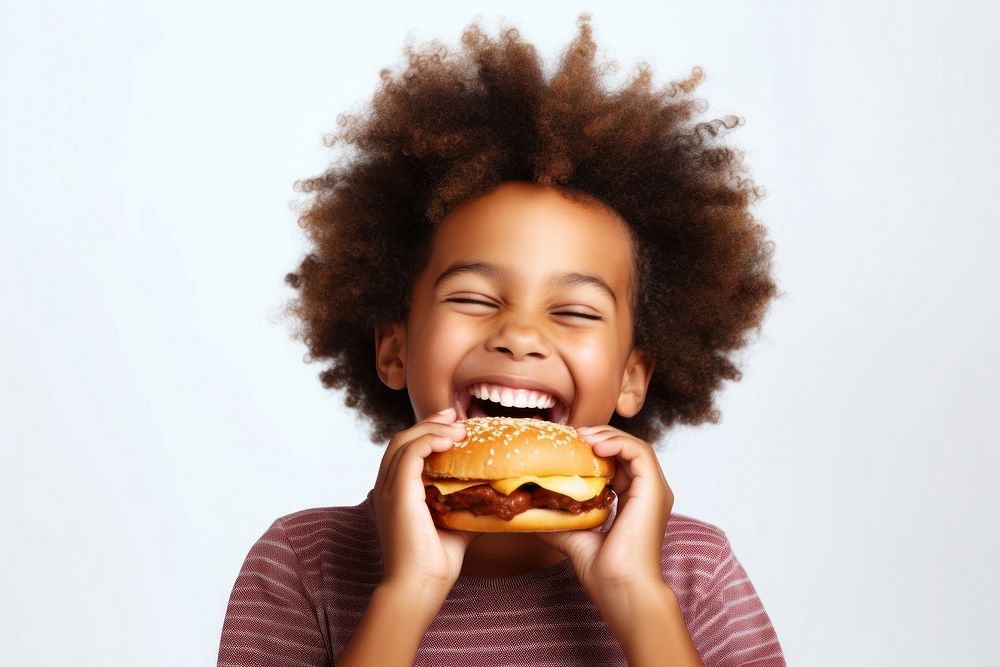 Cute little african boy enjoy eating a hamburger have fun biting child food. AI generated Image by rawpixel.