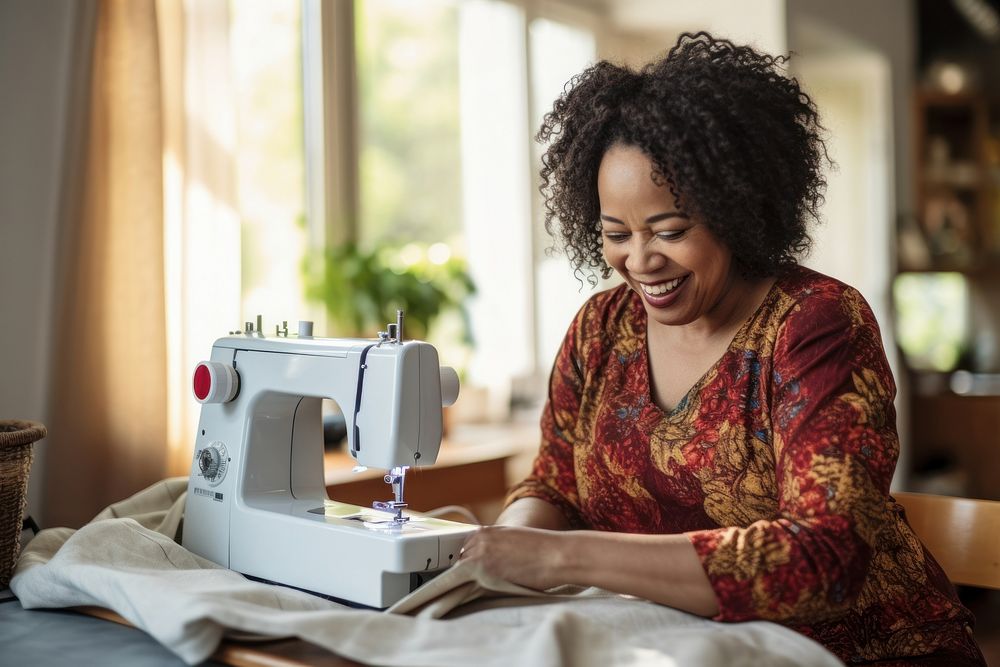 Using sewing machine smiling adult technology. 