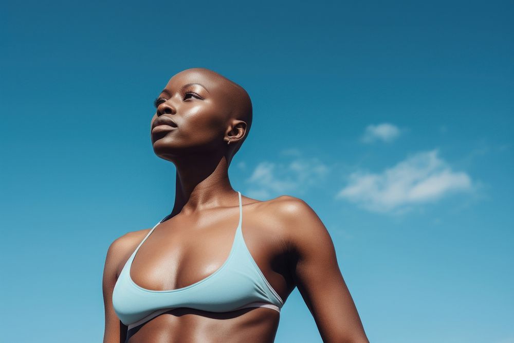 Black bald woman swimwear adult sky. 