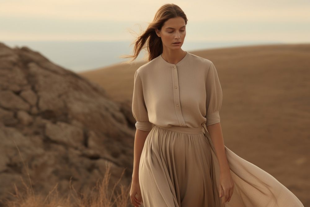 Woman standing wearing a minimal dress nature outdoors fashion. 