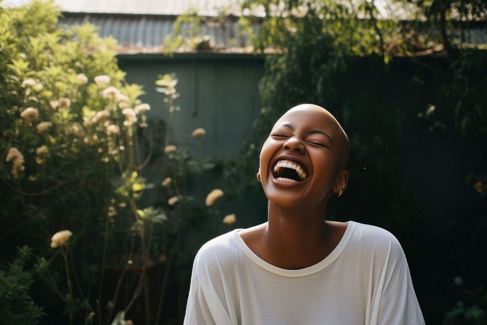 Bald black woman laughing outdoors adult architecture. 