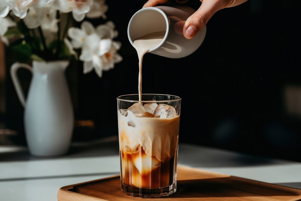 Iced coffee pouring drink milk. 