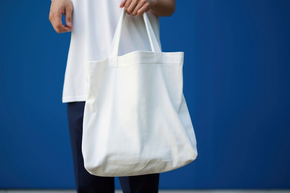 A white bag handbag person blue. AI generated Image by rawpixel.