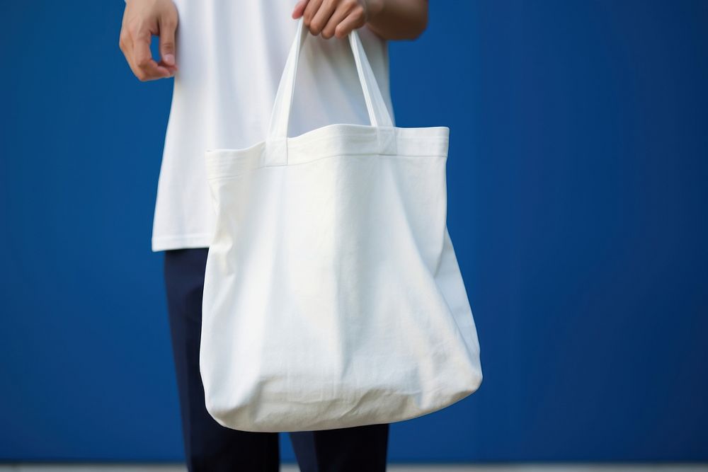 A white bag handbag person blue. 