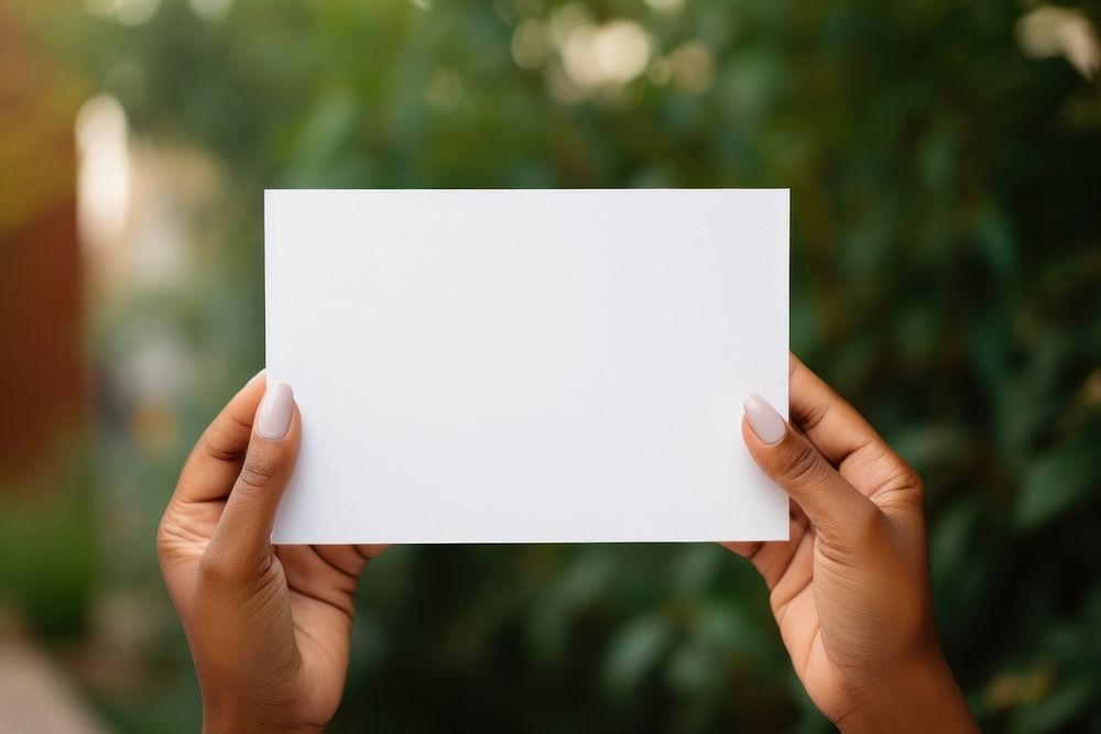 White card holding paper hand. 