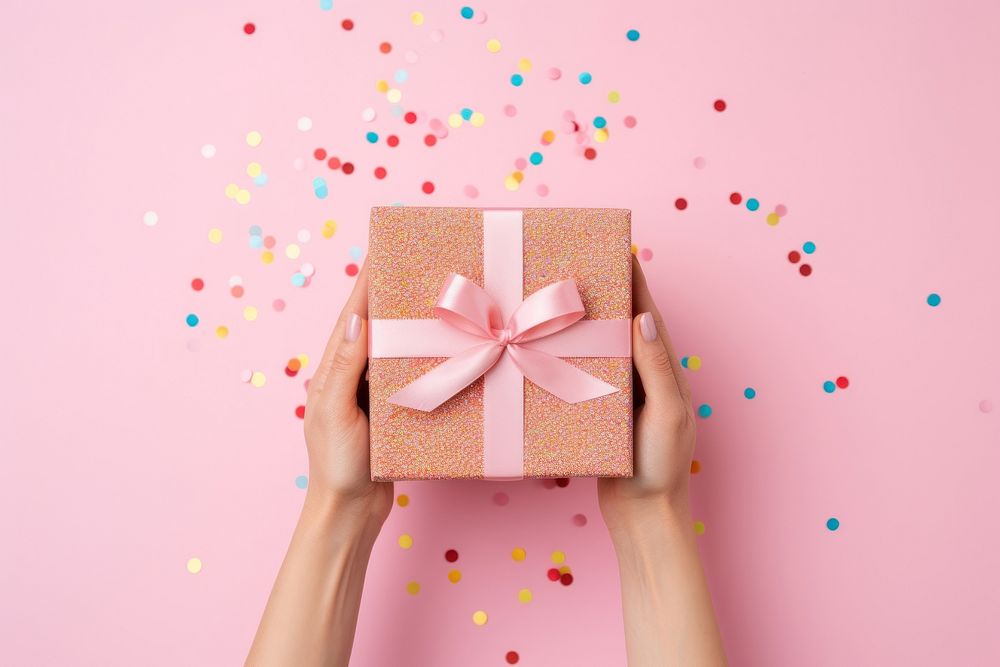 Holding present box confetti pink hand. AI generated Image by rawpixel.