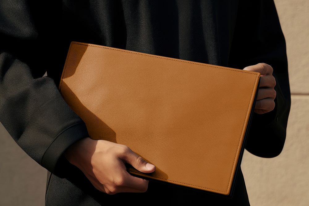 Brown leather clutch bag with design space